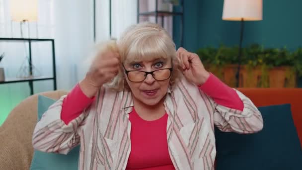 Abuela mayor haciendo expresiones de cara tontas juguetonas, muecas, tonterías, mostrando la lengua - Imágenes, Vídeo