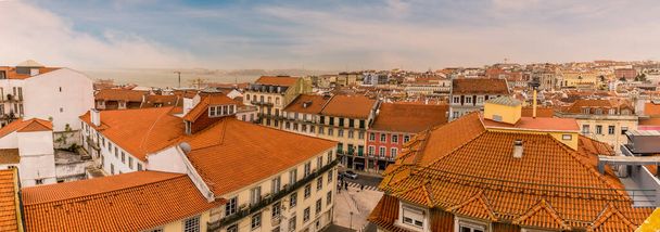 A view across the rooftops in the Alfama distict in the city of Lisbon on a spring day - Fotoğraf, Görsel