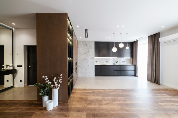 Modern interior design studio kitchen. Black furniture with kitchen - Photo, Image