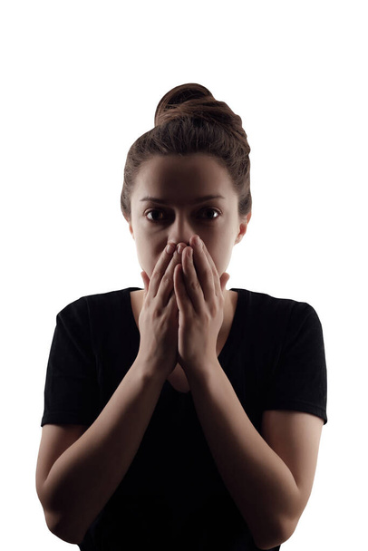 Silhouette of woman that closed her mouth by hands. Isolated portrait on white background - Photo, Image