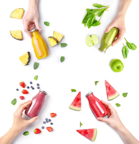 Hand holding fresh juicies in glass bottle isolated on white background - 写真・画像