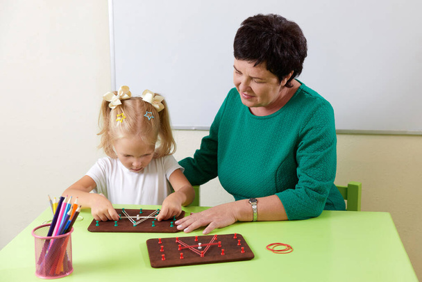 Adult woman teaches child the alphabet. Development of fine motor skills concept - Zdjęcie, obraz