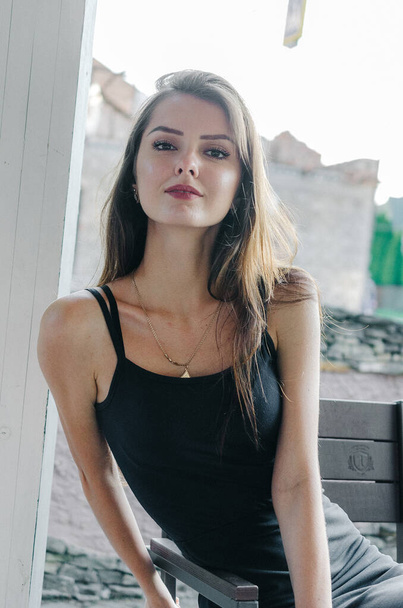 girl in a black T-shirt posing for the camera - Photo, image