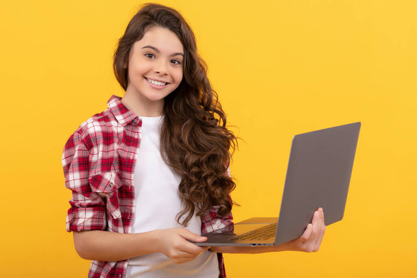 happy smart teen girl hold laptop during school online lesson, wireless technology - 写真・画像