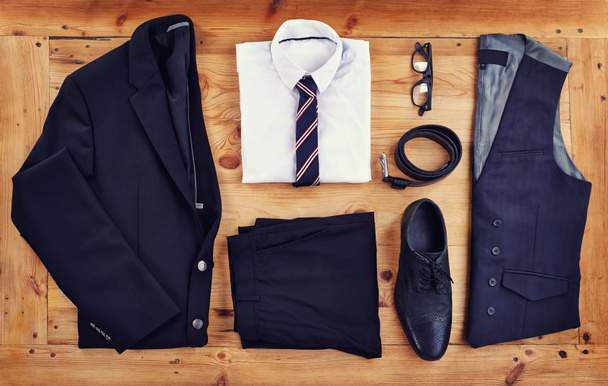 Stand out in the workplace with this stylish outfit. High angle shot of a stylish business outfit laid out on a wooden table. - Photo, Image