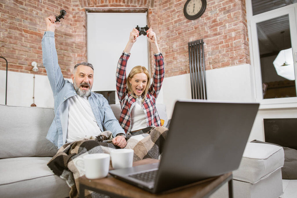 Mature family celebrating victory during video games - Photo, image