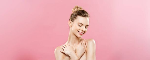 Beauty Concept - Beautiful Caucasian woman with clean skin, natural make-up isolated on bright pink background with copy space. - Фото, зображення
