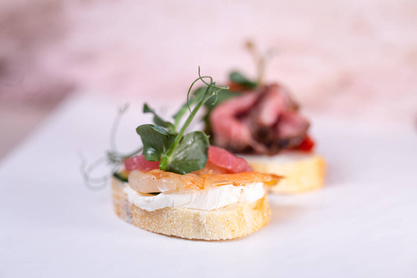 bruschetta with shrimp and cheese cream close-up. - Фото, изображение
