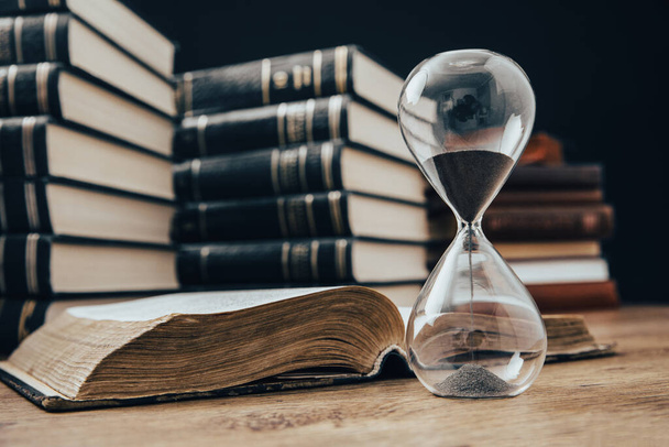 hourglass with book on the wooden backgroun - Photo, Image