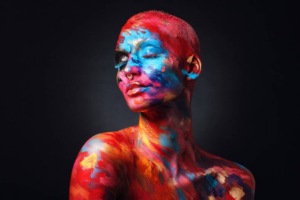 I feel complete in my art world. Shot of an attractive young woman posing alone in the studio with paint on her face and body. - Fotografie, Obrázek