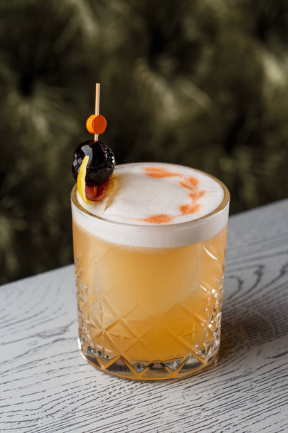 Pisco sour cocktail - whiskey with lime, egg white, sugar syrup in glass on dark background. Space for text - Фото, зображення