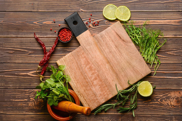 New cutting board and spices on wooden background - Photo, image