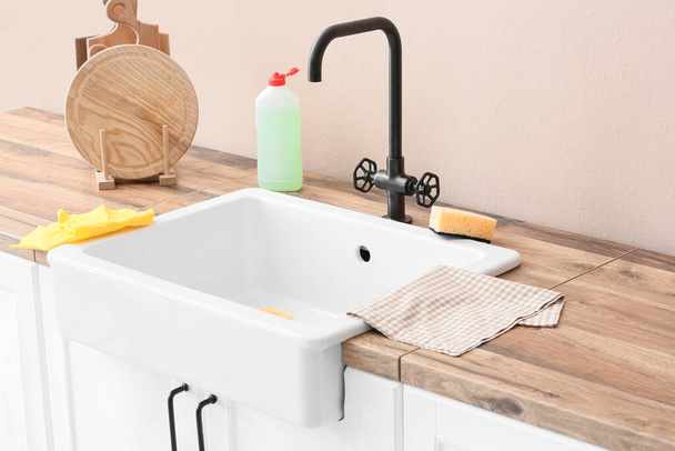 Cleaning sponges and detergent in ceramic sink - Foto, Bild