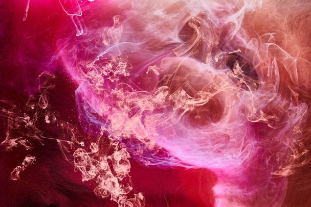 Multicolor pink smoke on black ink background, colorful fog, abstract swirling touch ocean sea, acrylic paint pigment underwater - Fotografie, Obrázek
