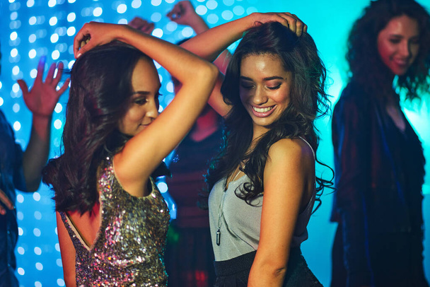 Shimmy and shake. Shot of a group of young people having fun on the dancefloor in a nightclub. - Φωτογραφία, εικόνα