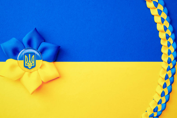 Ukraine flag symbol background. Ukrainian flower trident symbol isolated on yellow blue flag banner. Support Ukraine concept - Photo, Image