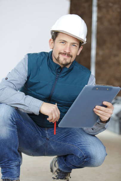man with clipboard working in a site - Foto, immagini