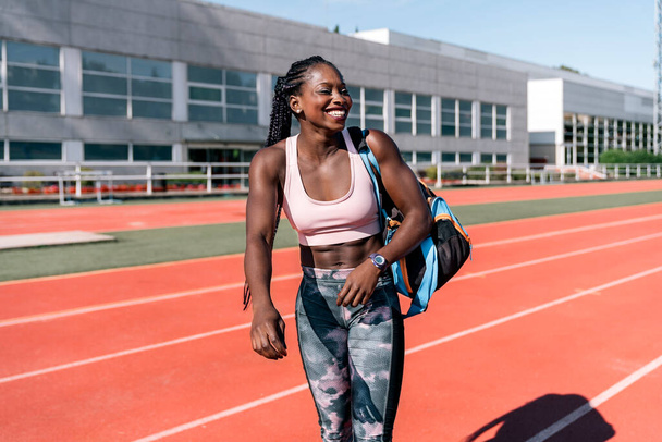 Athlete sprinter walking with training bag - Фото, зображення