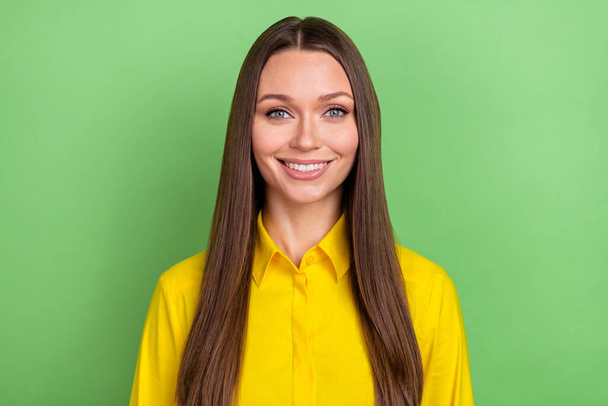 Photo of funny millennial brown hairstyle lady wear yellow shirt isolated on green color background - 写真・画像