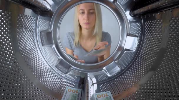 Woman counts money near washing machine, she throws each bill into drum and leaves it to wash. Laundry or saving family budget. Repairing washing machine under warranty is expensive. Service. - Metraje, vídeo