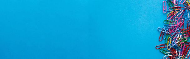 πάνω όψη πολύχρωμων συνδετήρων σε μπλε, banner - Φωτογραφία, εικόνα