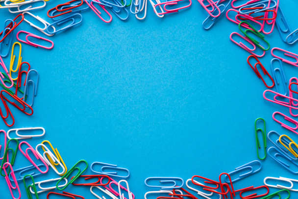 top view of frame with colorful paper clips on blue - Fotografie, Obrázek