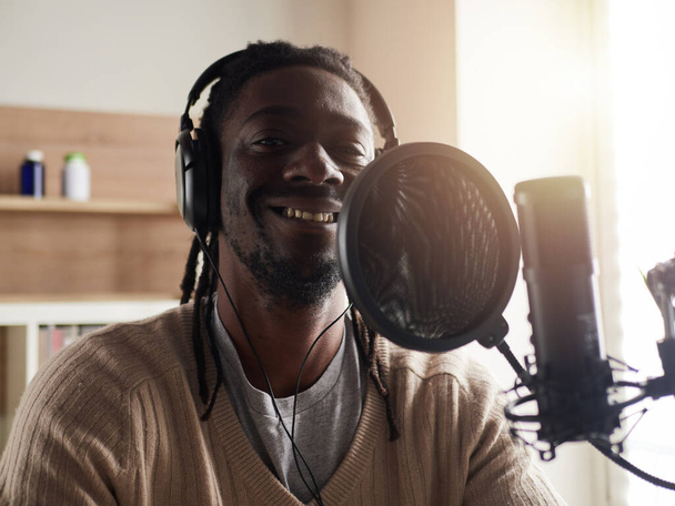 afroamerican  happy young male recording audio blog in headphones microphone broadcasting at home ... - Fotografie, Obrázek