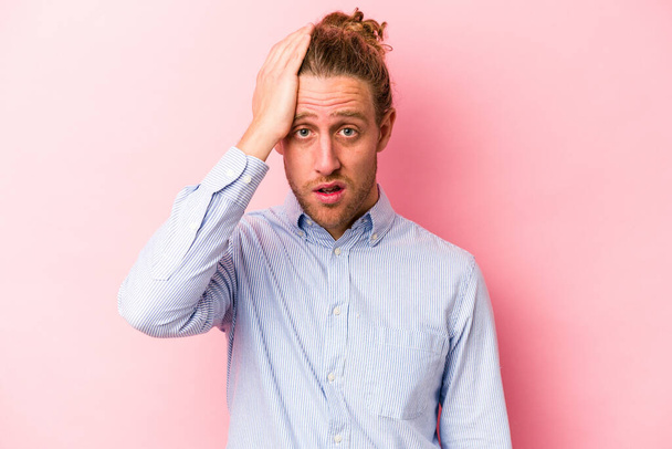 Young caucasian man isolated on pink background being shocked, she has remembered important meeting. - Photo, Image