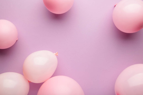 Birthday background with pink balloons on pink background, top view. Happy birthday - Фото, зображення