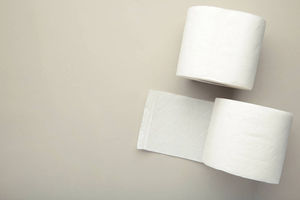 Roll of toilet paper on grey background, top view. Space for text - Fotó, kép