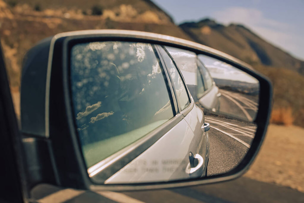 Side car mirror view close-up. Driving through the hills, road trip - Fotó, kép