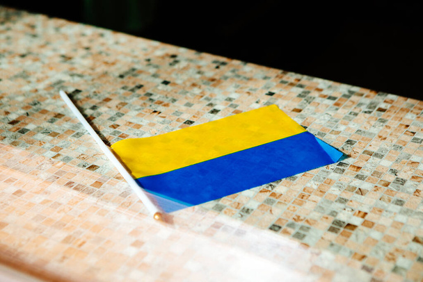 flag of ukraine blue yellow on table wooden background - Valokuva, kuva