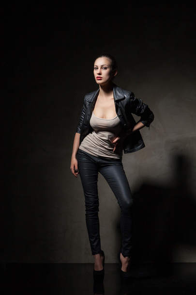 attractive woman in black leather jacket and pants - 写真・画像