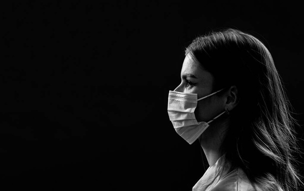 Faces of people in protective masks from coronavirus. Beautiful quarantined couple. Couple wearing a protective face mask, pandemic and feelings concept. Lifestyle COVID-19 - Photo, Image