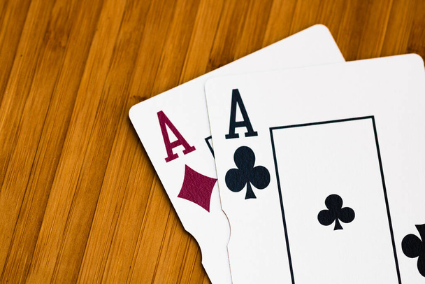 Playing cards aces card close up, isolated on wooden table. Casino concept, risk, chance, good luck or gambling. - Photo, Image