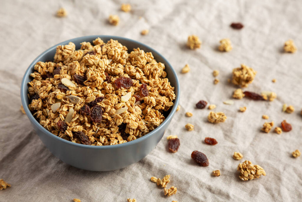 Homemade Granola with raisins and almonds  in a Bowl, side view.  - Photo, Image