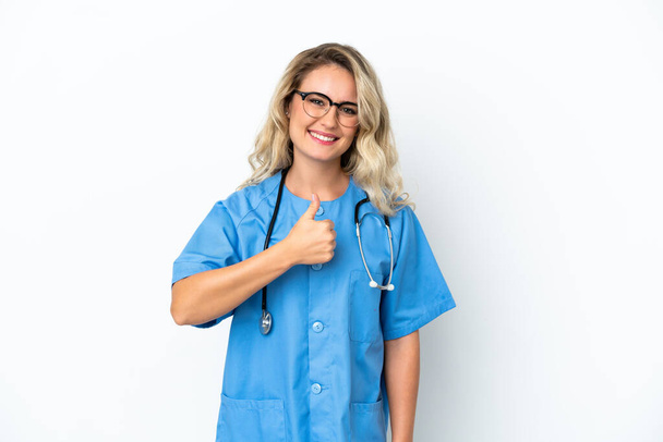 Brazilian surgeon doctor woman over isolated background giving a thumbs up gesture - Фото, изображение