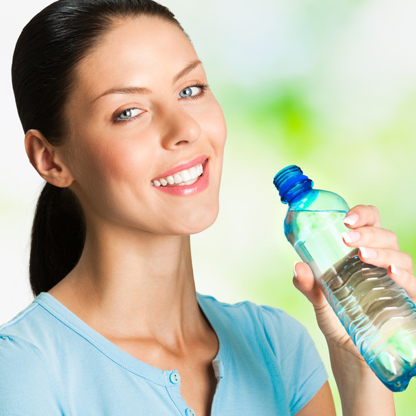 Young woman with bottle of water, outdoor - Foto, immagini