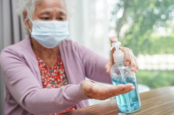 Asian elder senior woman patient wearing a protective mask for protect pollution environment and covid-19 coronavirus.    - Valokuva, kuva