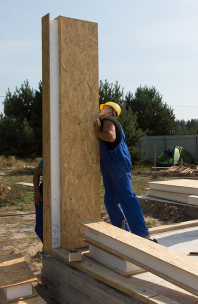 Builders positioning an upright wall panel - Foto, Imagen