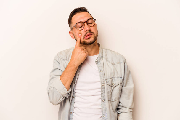 Young hispanic man isolated on white background crying, unhappy with something, agony and confusion concept. - Photo, image