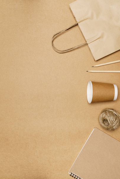 Eco friendly concept, Paper bag with cup and notebook pencil with jute rope on wooden background. - Fotoğraf, Görsel