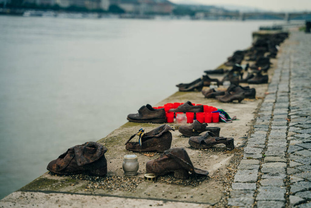 Shoes on the Danube bank - Monument as a memorial of the victims of the Holocaust in Budapest, Hungary - nov, 2021. High quality photo - Photo, Image