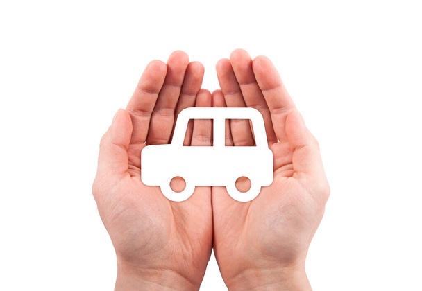 Car protection. Small paper car cutout covered by hands - Photo, image