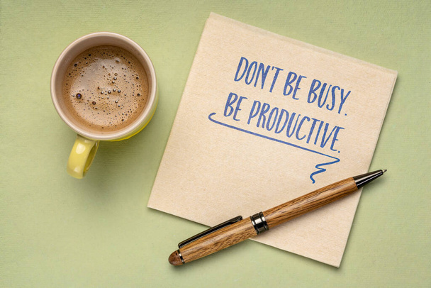 Don't be busy. Be productive. Handwriting on a napkin with a cup of coffee. Business and productivity concept. - Photo, image