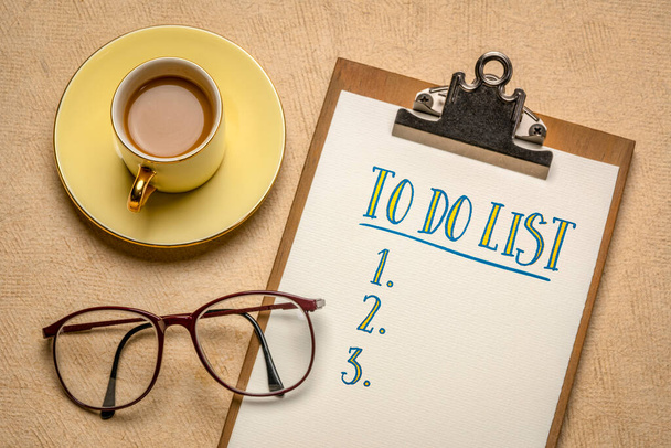 to do list handwriting in a clipboard, flat lay with a cup of coffee and glasses, business, productivity, planning and personal development concept - Zdjęcie, obraz