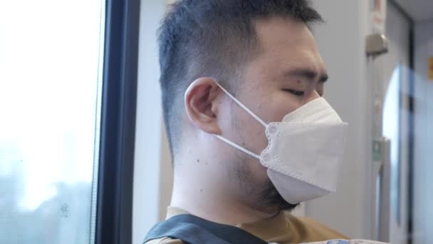 POV to a man wearing mask while ridding subway public transportation in Bangkok - Felvétel, videó