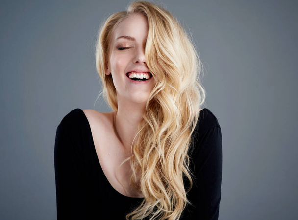 Never mind good hair day, have an awesome hair day. Studio portrait of an attractive young woman with beautiful long blonde hair laughing against a gray background. - Fotoğraf, Görsel