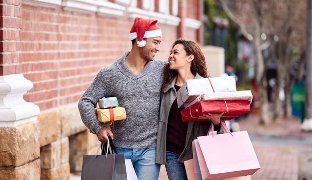 Noel alışverişlerini erken yapıyorlar. Sevecen genç bir çiftin şehirde alışveriş yaparken çekilmiş görüntüsü.. - Fotoğraf, Görsel