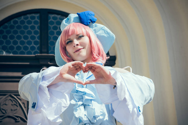 a woman dressed up as an anime character with hands as a heart - Fotoğraf, Görsel